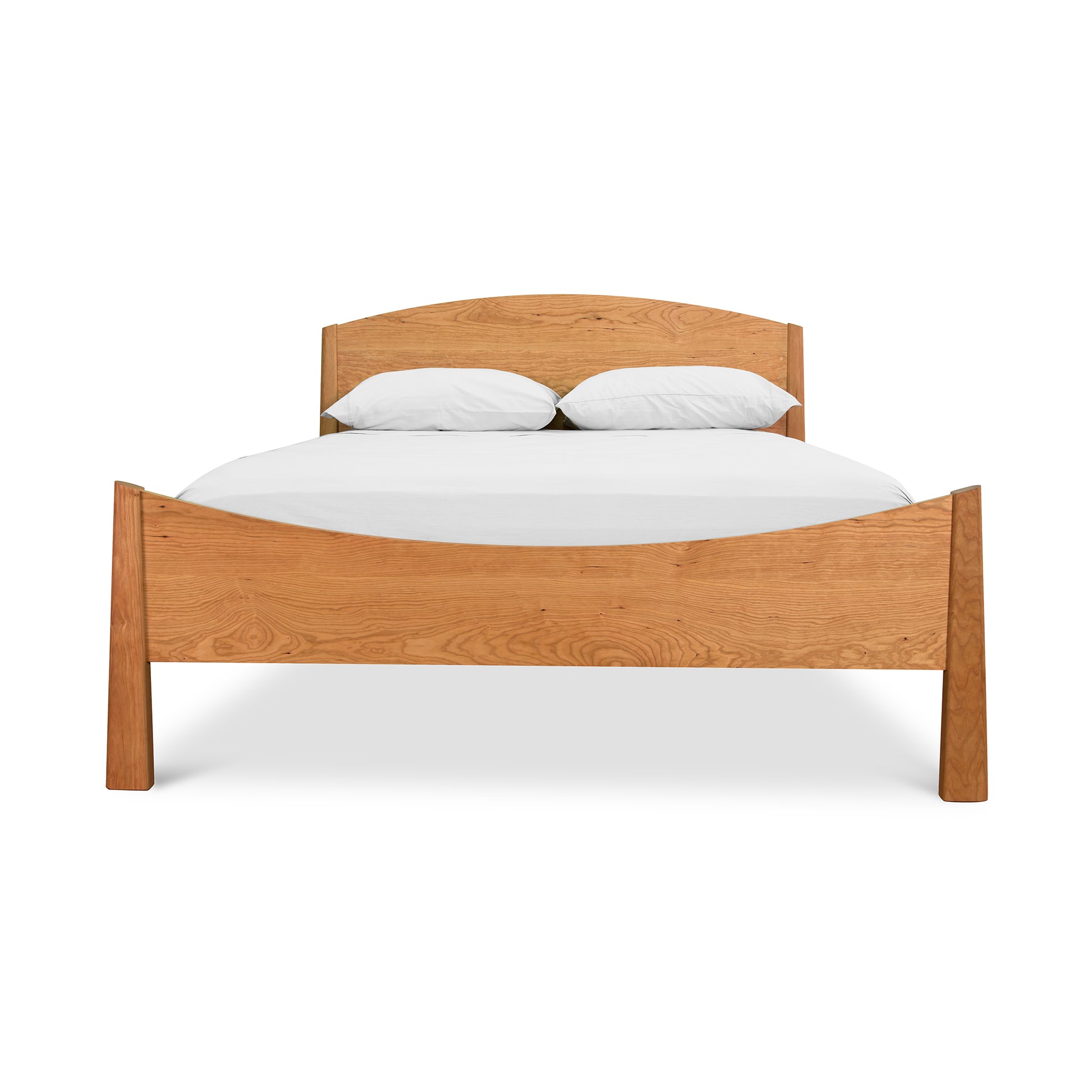 A Maple Corner Woodworks Cherry Moon Bed frame with a headboard, fitted with white bedding and two pillows, isolated on a white background.