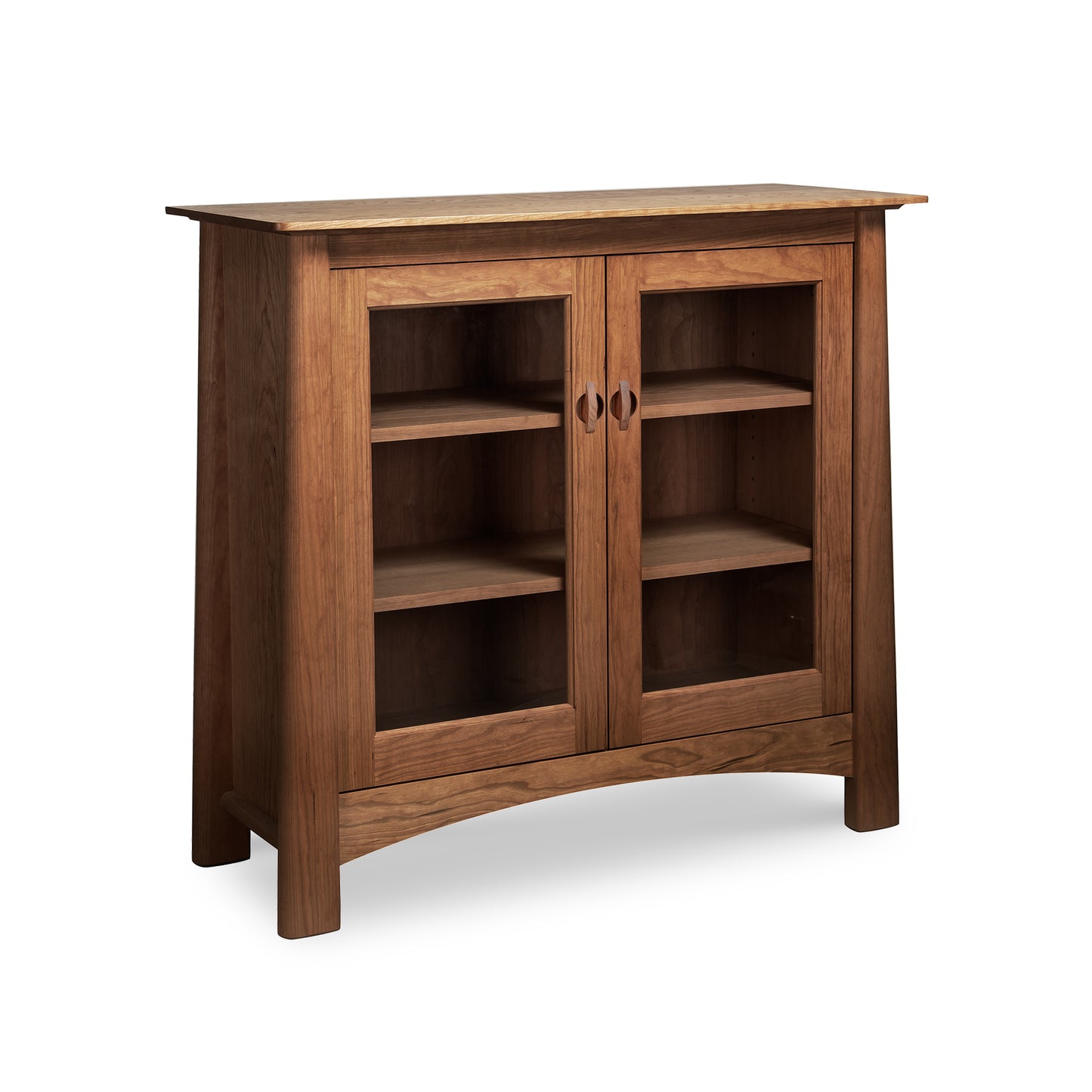 Maple Corner Woodworks Cherry Moon Bookcase with two glass doors, three shelves, and four legs; crafted from cherry wood.