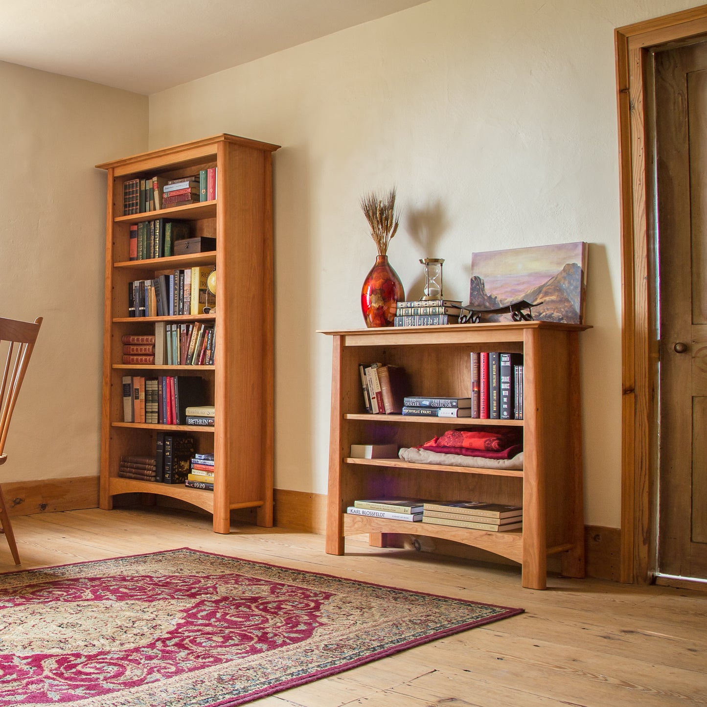 Cherry Moon Bookcase from Maple Corner Woodworks showcasing elegant craftsmanship and rich wood finish, with books and decor on its spacious shelves.