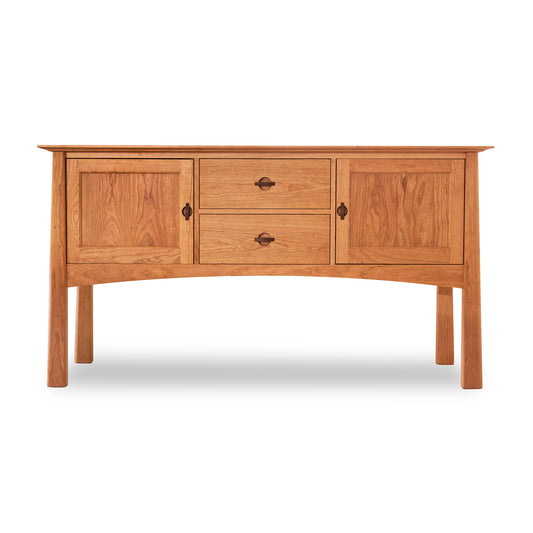 Wooden huntboard from the Cherry Moon Furniture Collection by Maple Corner Woodworks, featuring two cabinet doors, two central drawers with round handles, and subtly curved legs, exemplifying understated luxury.