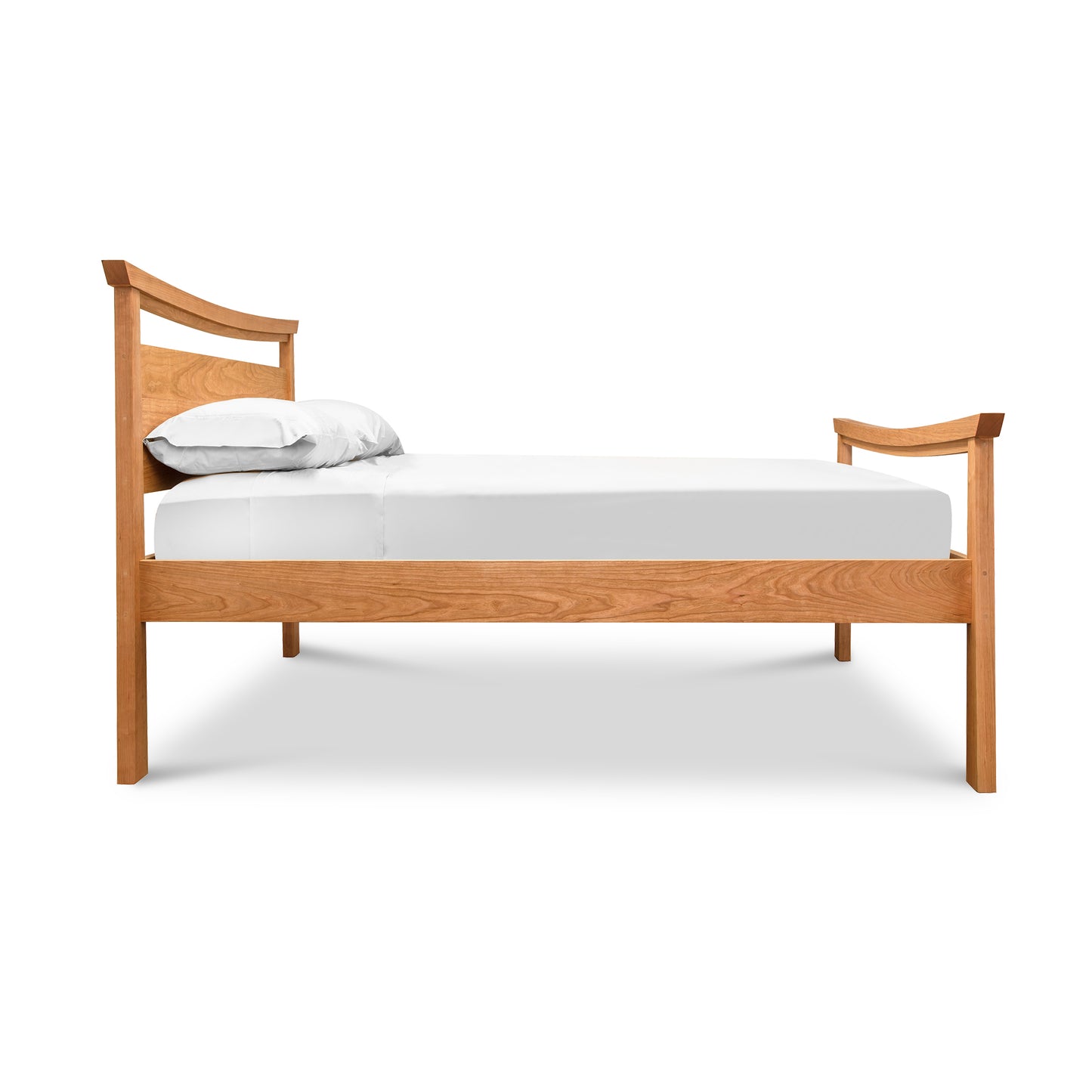 Elegant Cherry Moon Pagoda Bed with curved headboard and footboard, crafted by Maple Corner Woodworks, showcasing a rich wooden frame with a white mattress and two pillows.