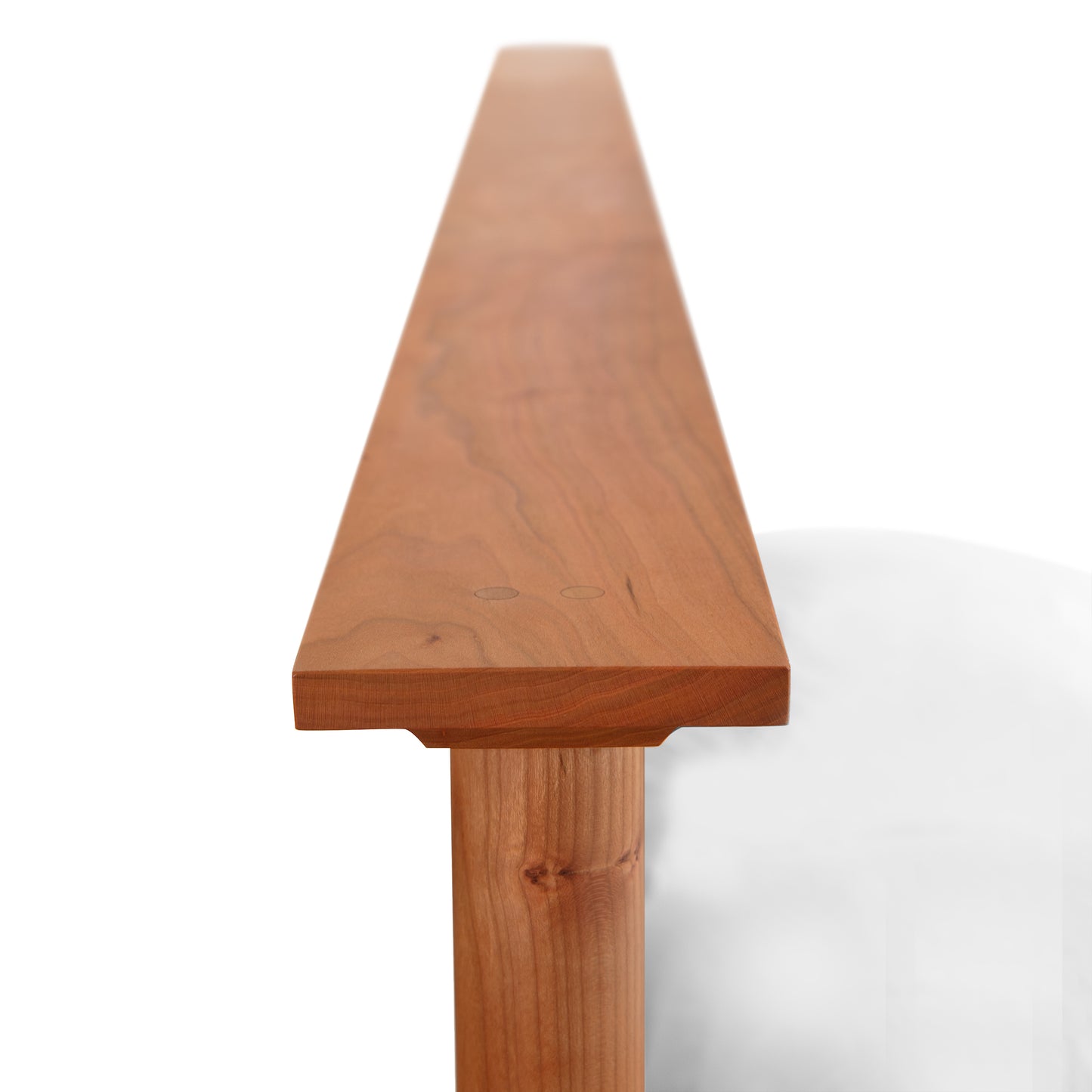 Detail view of the Cherry Moon Panel Bed by Maple Corner Woodworks, showcasing the handcrafted cherry wood corner and panel design.