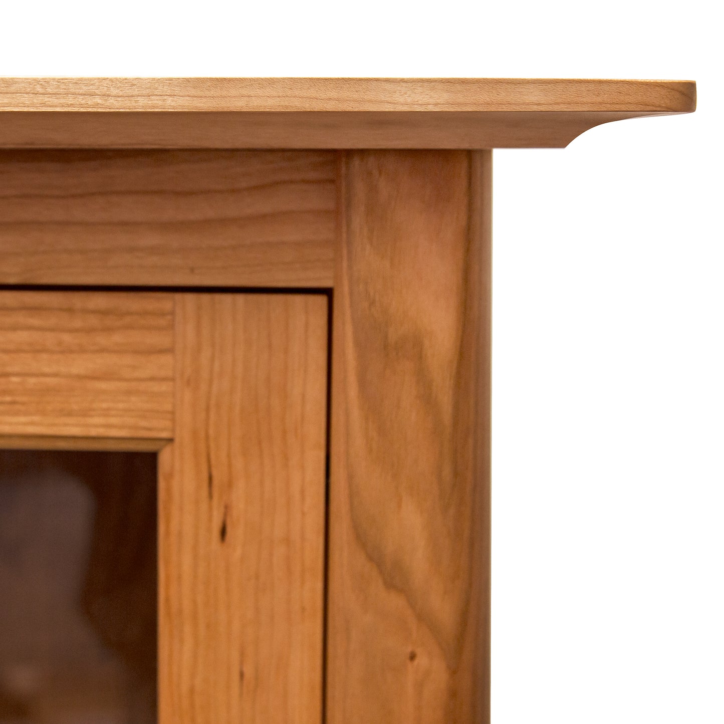 Close-up of Cherry Moon Small China Cabinet by Maple Corner Woodworks, highlighting detailed wood grain and exceptional joinery in natural hardwood.