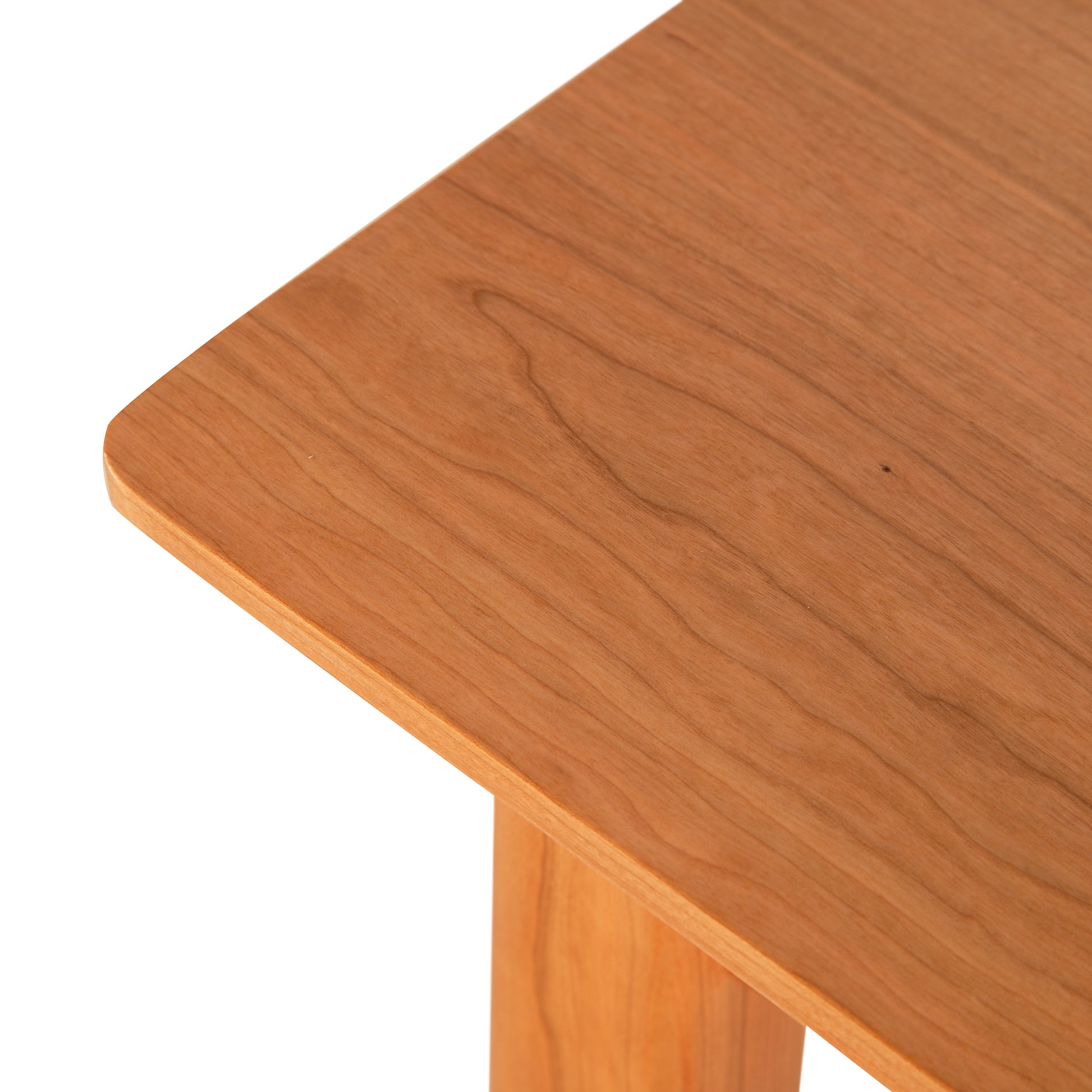 Cherry Moon Sofa Table by Maple Corner Woodworks featuring a smooth, light-brown finish and intricate grain patterns on the surface and leg, highlighting its American-made craftsmanship and handcrafted elegance.