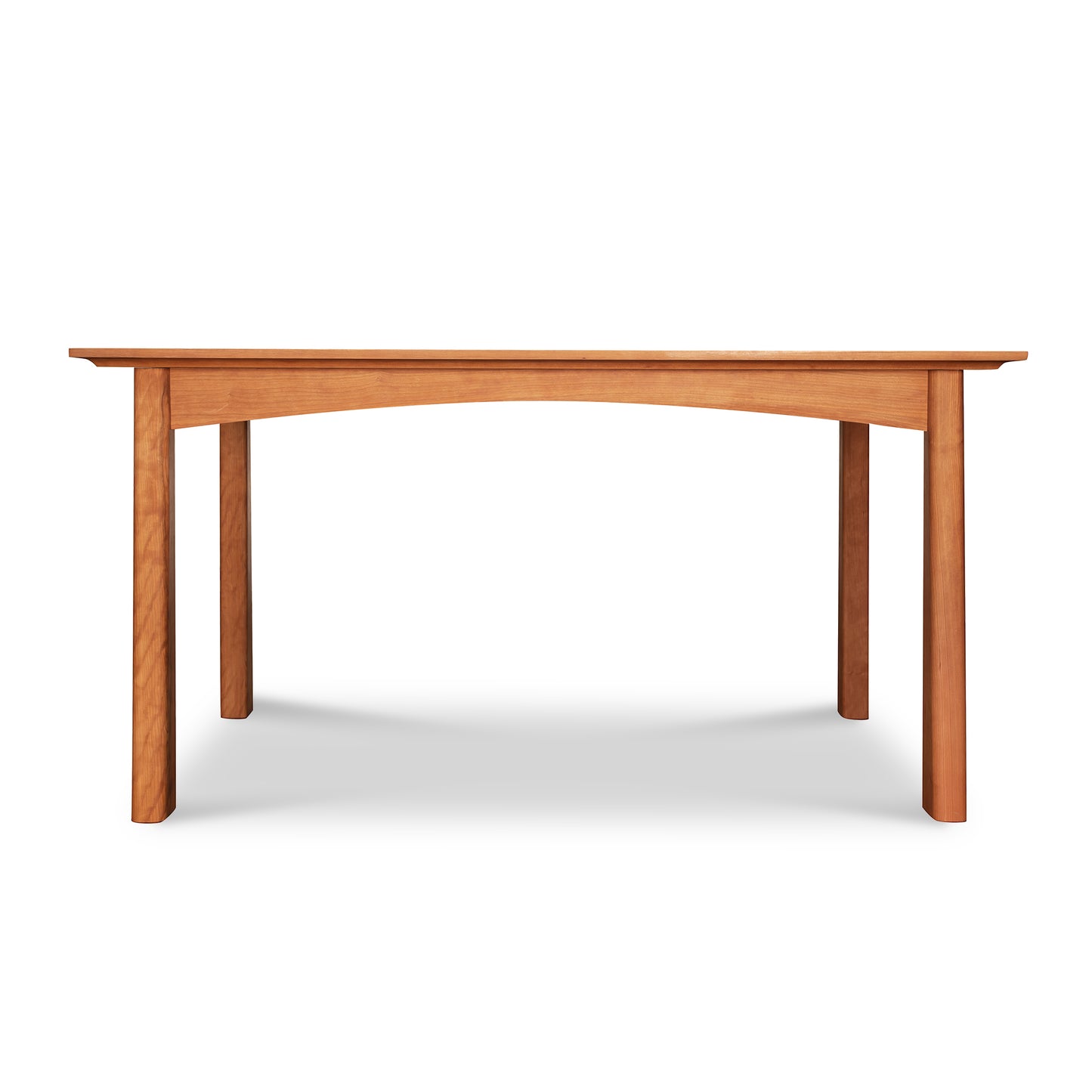 Cherry Moon Solid Top Dining Table by Maple Corner Woodworks crafted in natural solid wood, featuring a rectangular top and four robust legs with a slightly arched apron in the Arts & Crafts style.