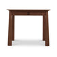 A Maple Corner Woodworks Cherry Moon Writing Desk, viewed from the front against a white background.