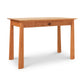 Maple Corner Woodworks Cherry Moon Writing Desk, with a single central drawer, isolated on a white background.