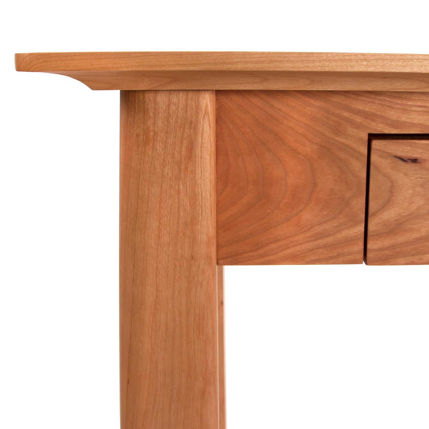 Close-up of the Maple Corner Woodworks Cherry Moon Writing Desk, showcasing its smooth, polished eco-friendly hardwood surface with natural grain lines and gently curved edges, handcrafted in Vermont.