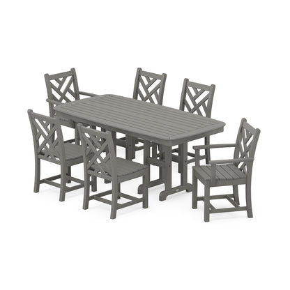 A modern outdoor dining set with six gray chairs and a matching rectangular table, all made from POLYWOOD® Chippendale, designed to resemble wood. The chairs feature a criss-cross back design reminiscent of the Chippendale style.
