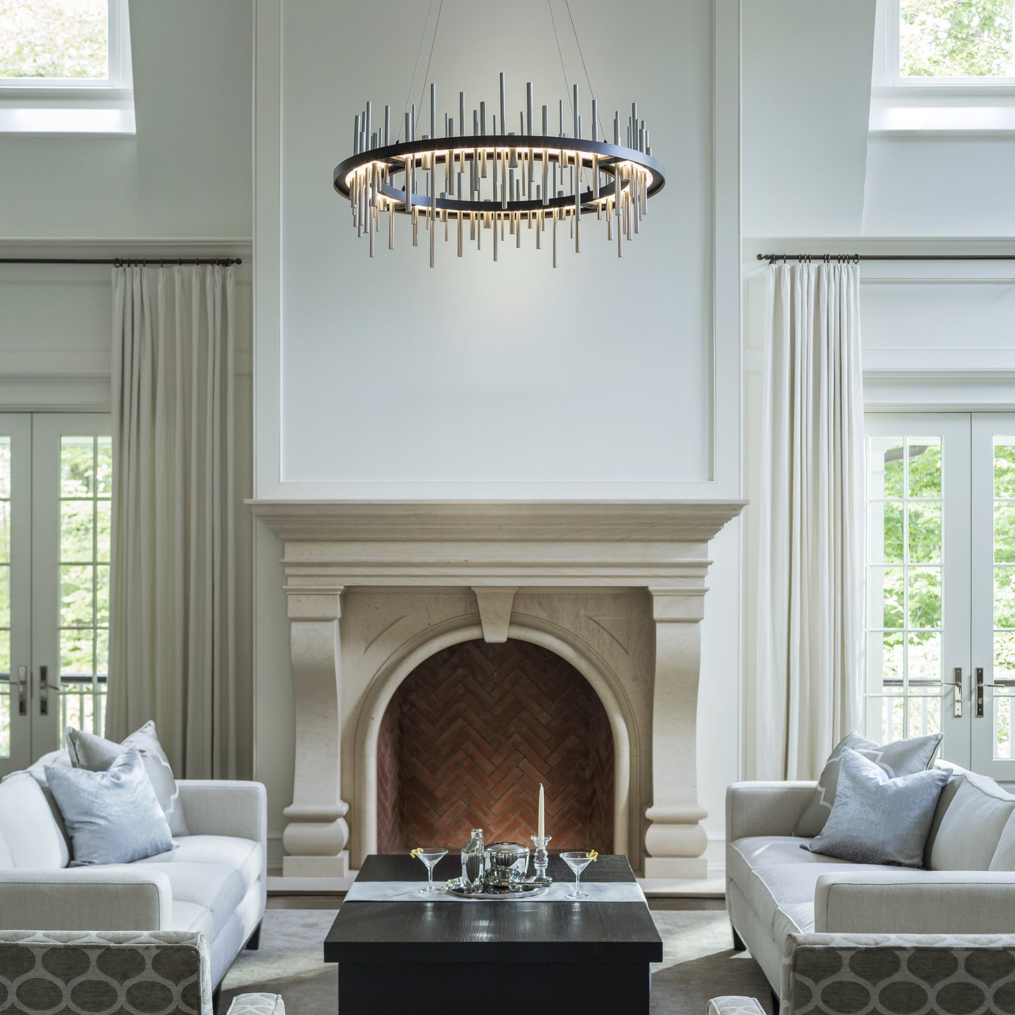 Elegant white sofas paired with a Hubbardton Forge Circular Cityscape Pendant, showcasing exquisite American craftsmanship.