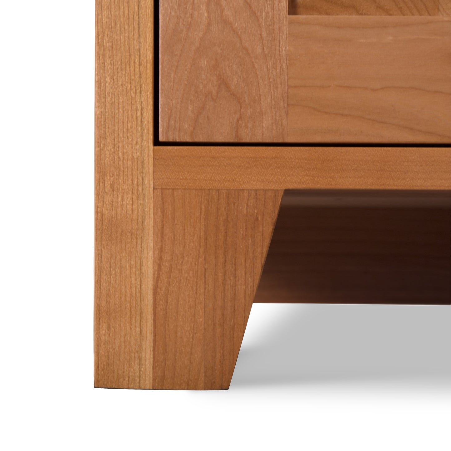 Close-up of the Classic Country Buffet leg by Lyndon Furniture, showcasing Vermont craftsmanship and clean lines in light brown.