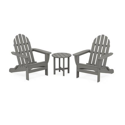 Two gray POLYWOOD Classic Folding Adirondack chairs facing each other with a small round table in between, set on a plain white background.