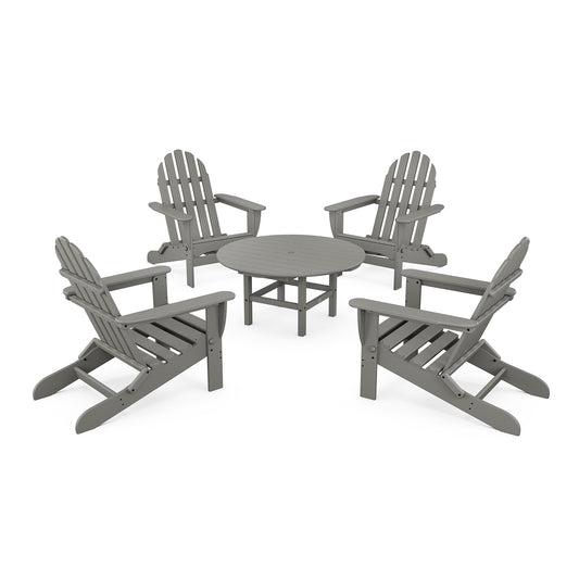 Four gray POLYWOOD Classic Folding Adirondack chairs arranged around a small matching round table on a plain white background. The chairs feature a classic slatted design.
