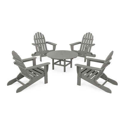 Four POLYWOOD® Classic Folding Adirondack chairs arranged around a small, round matching table on a plain white background, suggesting a relaxed outdoor conversation set.