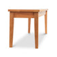 A Lyndon Furniture Classic Shaker Bench with solid wood legs placed on a white background.