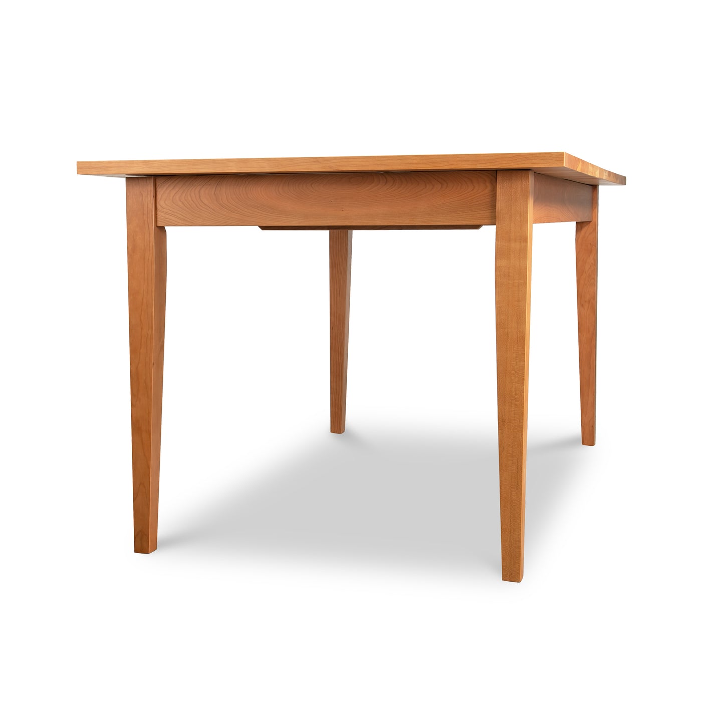 Classic Shaker Butterfly Extension Table by Lyndon Furniture in solid wood, viewed from a low angle, highlighting craftsmanship and design.