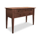 An eco-friendly Classic Shaker Hunt Board console table with drawers and tapered legs on it.
