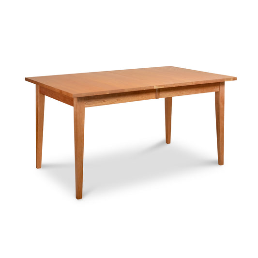 The Classic Shaker Extension Dining Table - Floor Model by Lyndon Furniture is a mid-century modern 20th century furniture design, featuring a wooden construction and two legs. It is showcased on a crisp white background, making it an