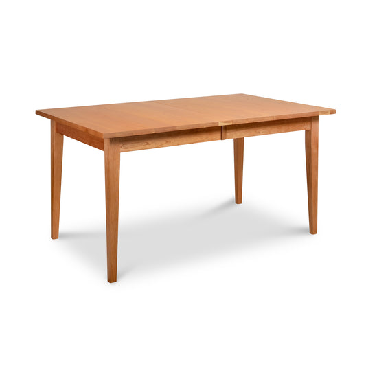 Image of a rectangular solid wood dining table with clean lines and four tapered legs. This Classic Shaker 36"x60" Extension Dining Table - Floor Model by Lyndon Furniture has a smooth, natural wood finish. The minimalist design is reminiscent of classic Shaker furniture, showcasing handmade craftsmanship and durable solid wood construction, perfect for American made furniture enthusiasts.