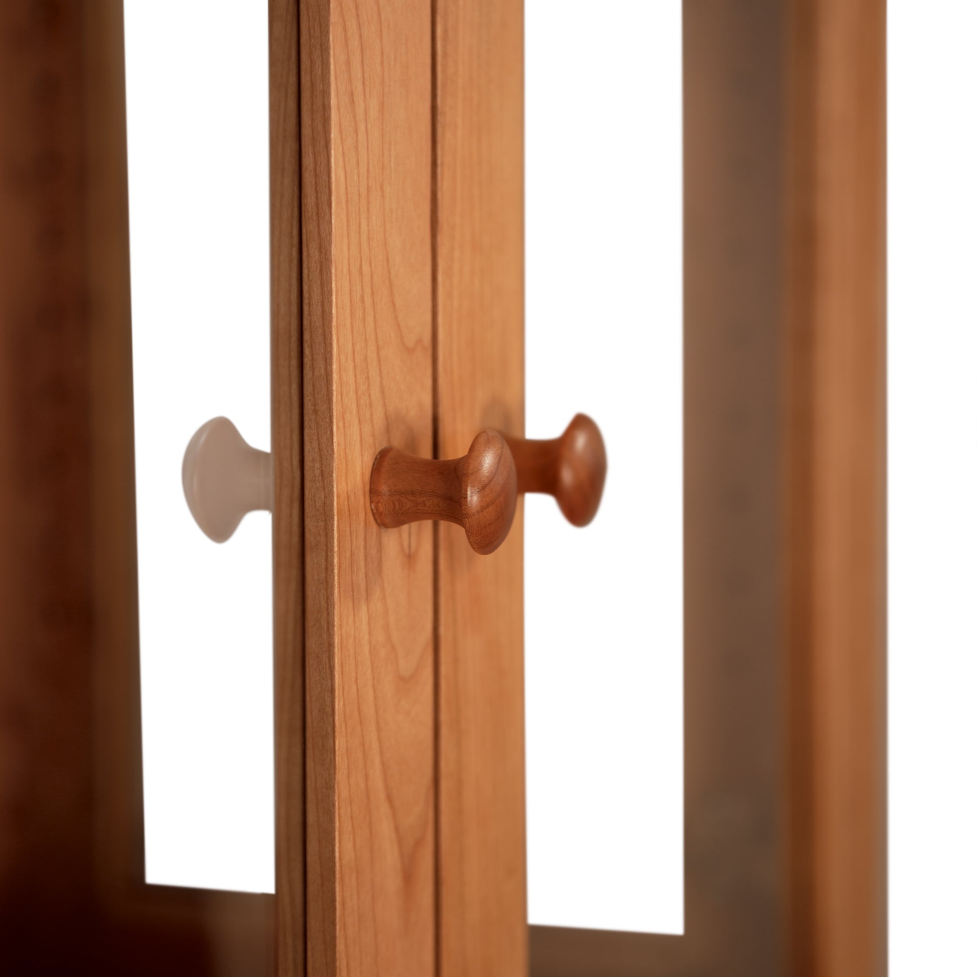 Lyndon Furniture Classic Vermont Curio Cabinet with vertical glass panel doors and round wooden handles, highlighting craftsmanship and detail.