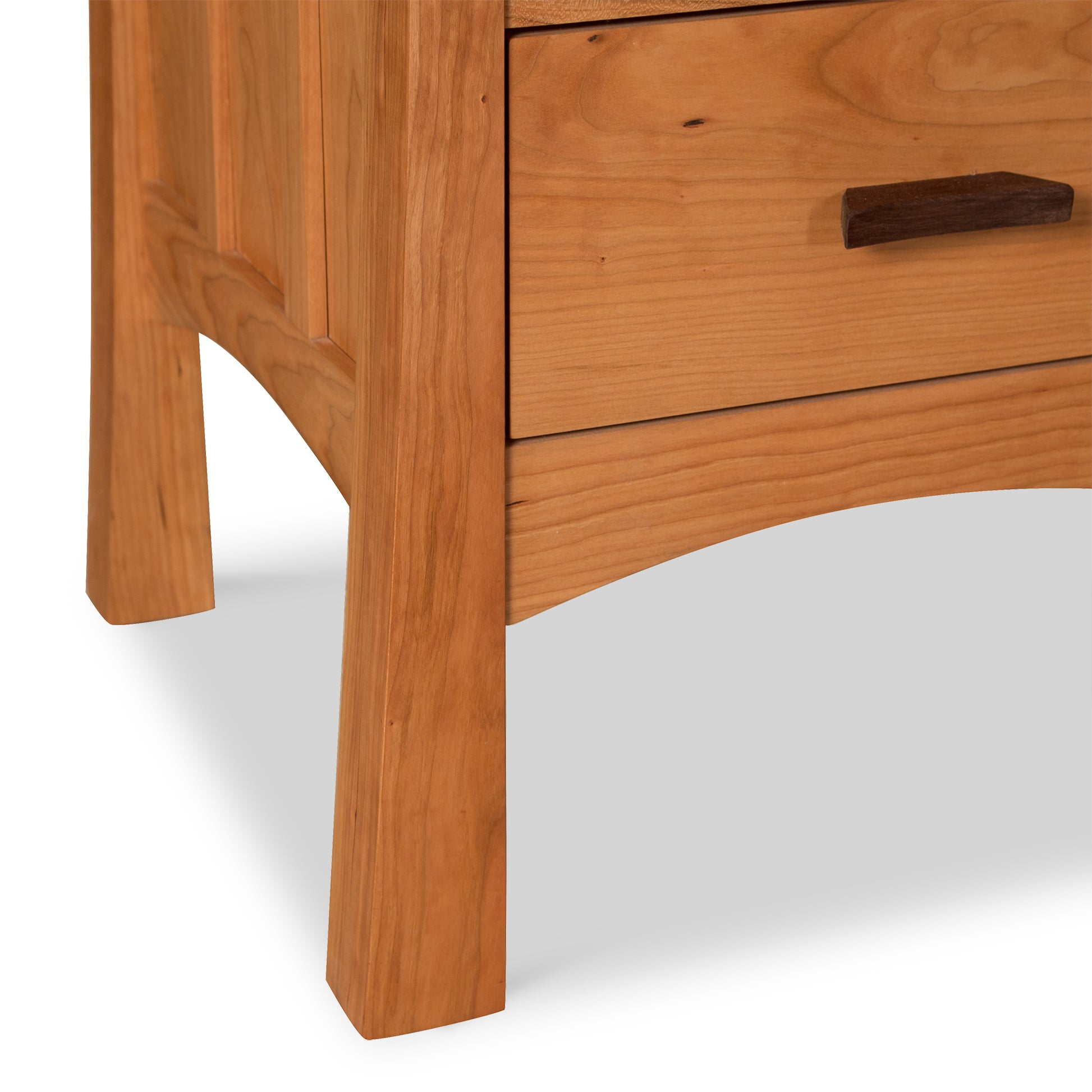 Vermont Furniture Designs Contemporary Craftsman 3-Drawer Nightstand featuring wood handles and curved skirting, showcasing fine craftsmanship and modern design.