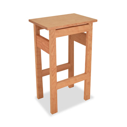 A Contemporary Asian Stool by Maple Corner Woodworks, made with natural wood and eco-friendly materials, isolated on a white background.