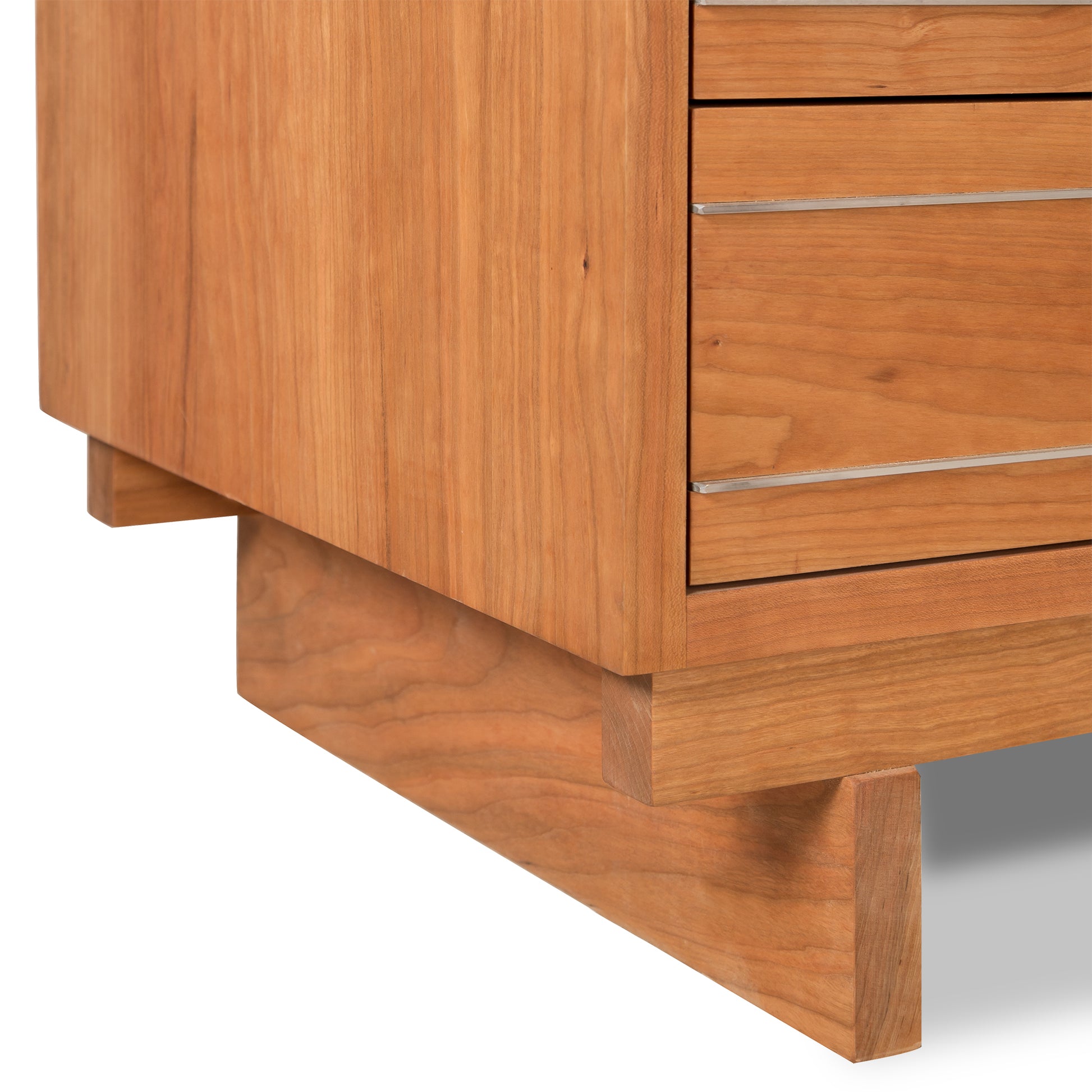 A Contemporary Cable 3-Drawer Chest, handcrafted in Vermont by Vermont Furniture Designs, with a simple, modern design, showing a partial view focused on the corner with drawers and a sturdy base.