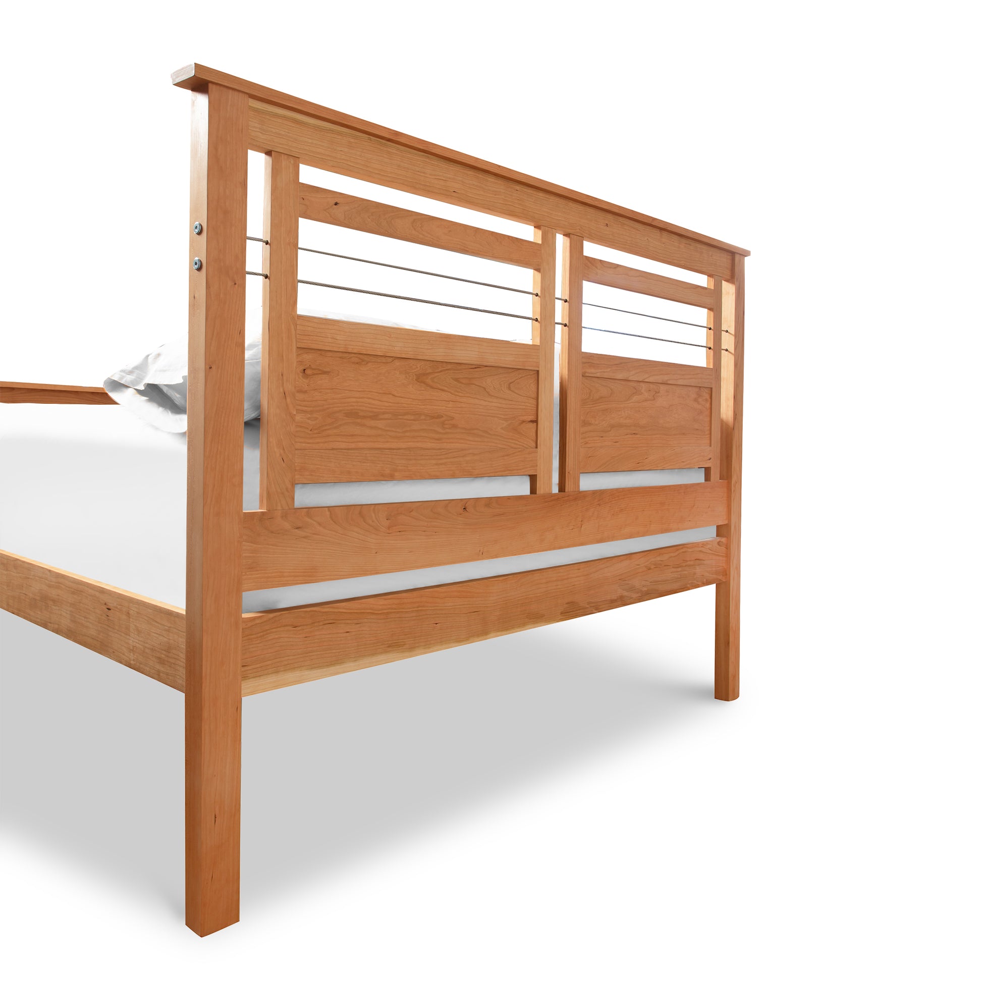 A Vermont Furniture Designs Contemporary Cable Bed frame with a slatted headboard, partially dressed with a single crumpled white pillowcase on the right corner, isolated against a white background.