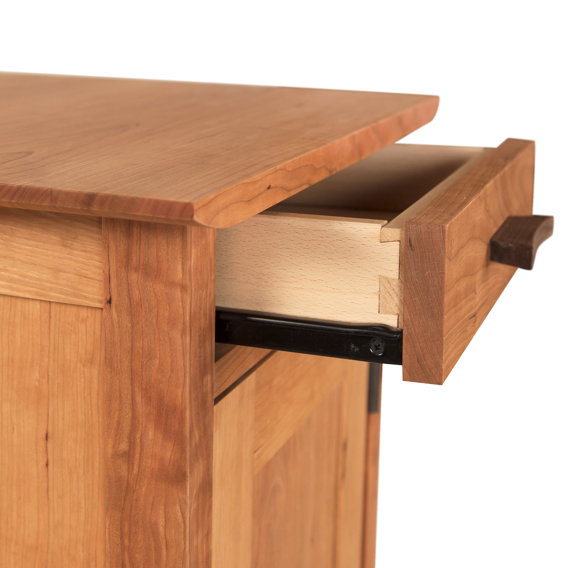 Partially opened wooden drawer of a Vermont Furniture Designs Contemporary Craftsman 1-Drawer Nightstand with Door showing dovetail joints and a metal slide mechanism with an eco-friendly oil finish.