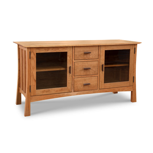 A Vermont Furniture Designs Contemporary Craftsman 3-Drawer Media Console, an eco-friendly sideboard with two glass-doored cabinets and three drawers on a white background.