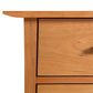 Close-up of a Vermont Furniture Designs Contemporary Craftsman 5-Drawer Chest, showing a tabletop corner and a drawer front with a shadow across it.