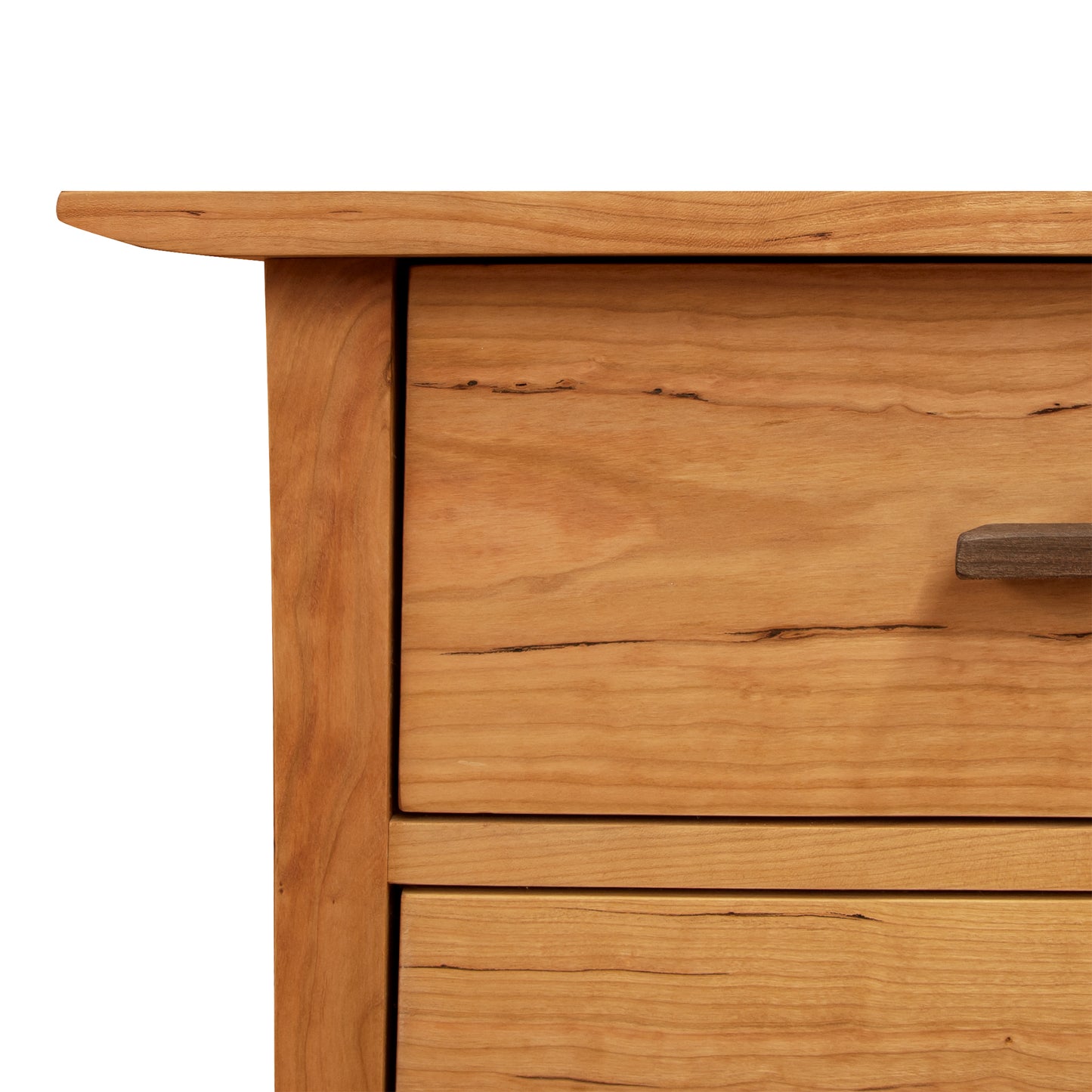 Close-up of a wooden desk corner with a drawer featuring minimalist walnut drawer pulls, showcasing seamless craftsmanship and natural wood grain details. White background. - Close-up of a Vermont Furniture Designs Contemporary Craftsman 6-Drawer Dresser corner with a drawer featuring minimalist walnut drawer pulls, showcasing seamless craftsmanship and natural wood grain details. White background.