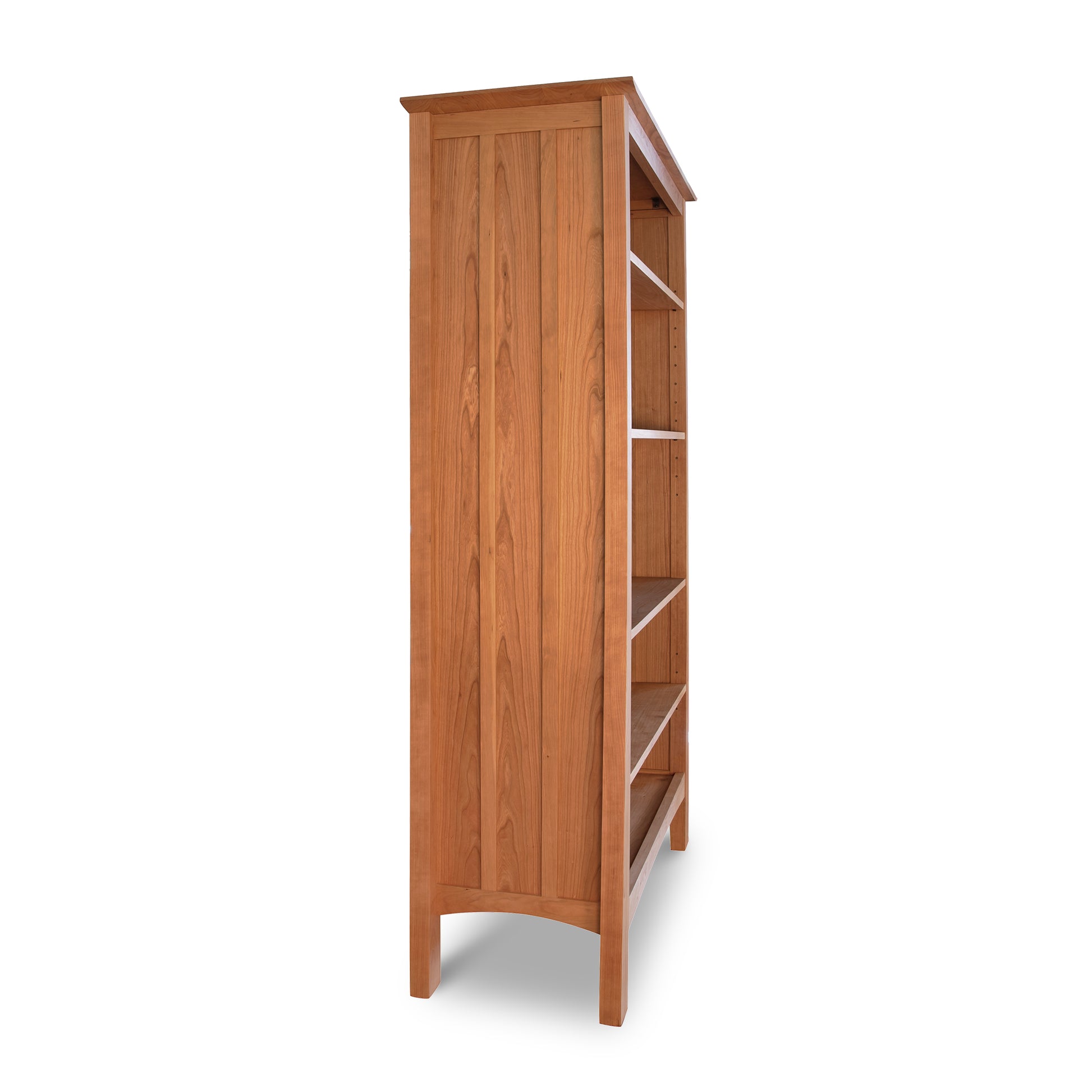 Wooden bookshelf with a closed cabinet on the left and open shelves on the right, isolated on a white background. This Vermont Furniture Designs Contemporary Craftsman Custom Bookcase is handmade, ensuring quality and uniqueness.