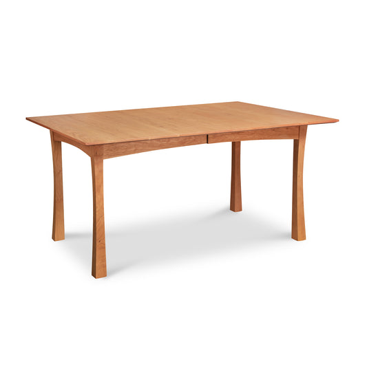 A Contemporary Craftsman Extension Dining Table, crafted by Vermont Furniture Designs woodworkers, isolated on a white background.