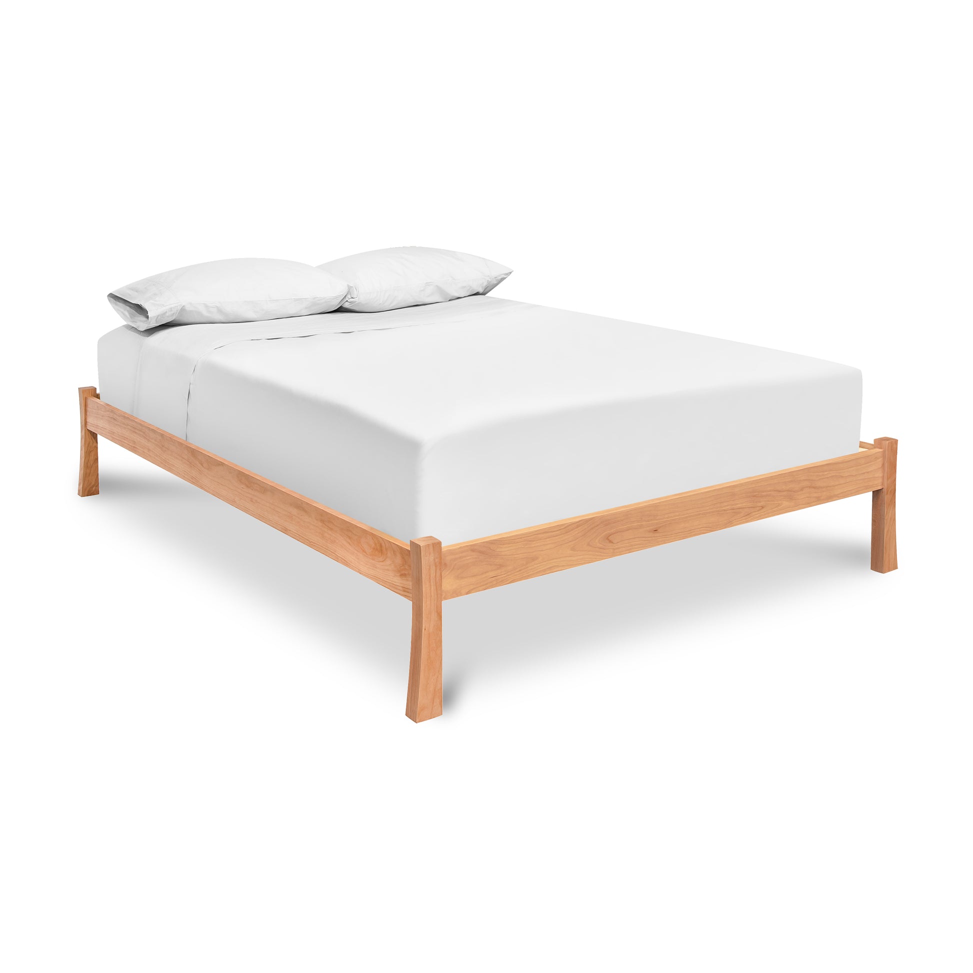 A Vermont Furniture Designs Contemporary Craftsman Studio-Style Platform Bed with white bedding isolated on a white background.