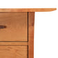 Corner of a Contemporary Craftsman Study Desk by Vermont Furniture Designs with a smooth, eco-friendly finish, featuring a rounded edge and a drawer with a handle, isolated on a white background.