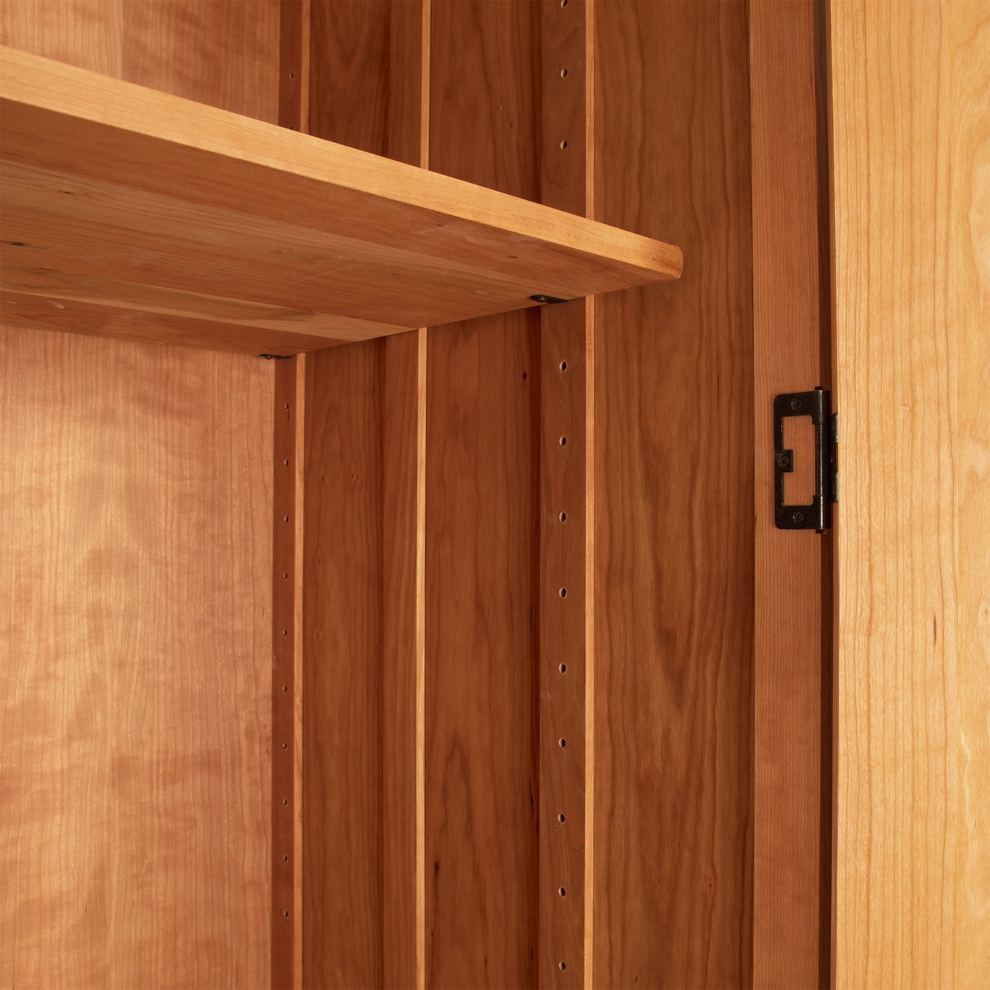 Interior detail of the Contemporary Craftsman Tall Armoire showcasing expert wood craftsmanship and quality construction by Vermont Furniture Designs.