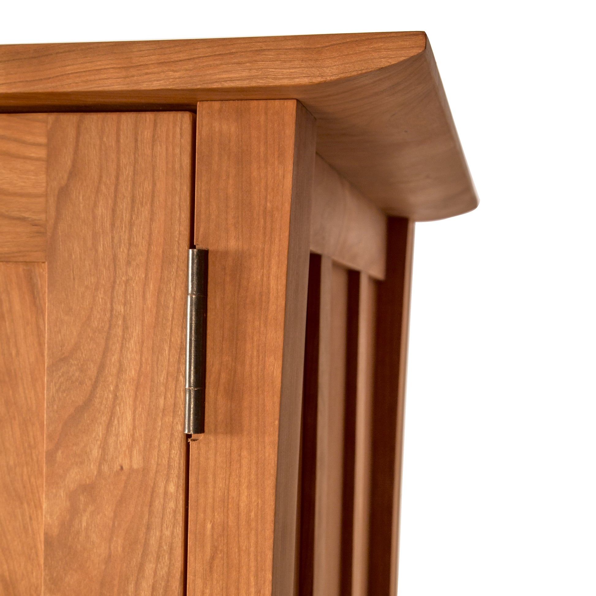 Close-up of a Vermont Furniture Designs Contemporary Craftsman Tall Storage Chest corner showing the detailed craftsmanship, hinge, and grain of the wood, complemented by an eco-friendly oil finish.