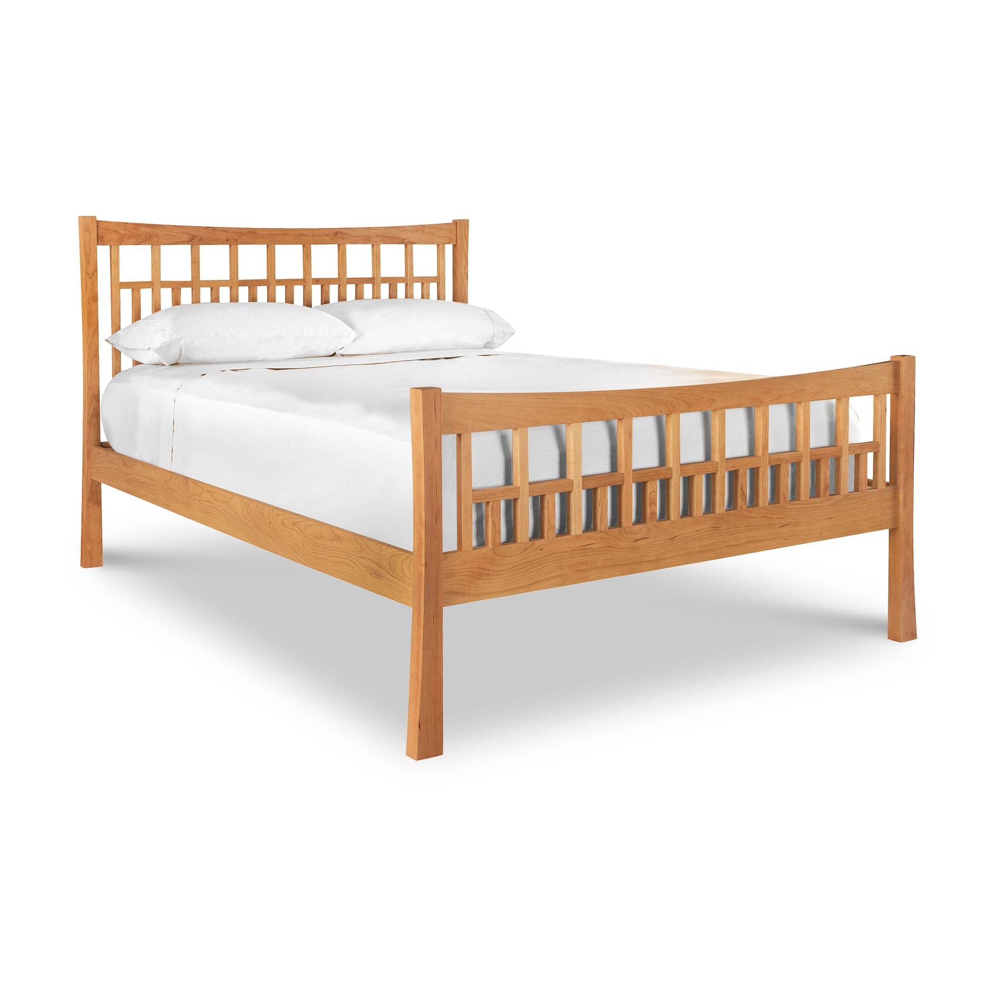 A Vermont Furniture Designs Contemporary Craftsman High Footboard Bed with slatted headboard and footboard, made up with white bedding, isolated on a white background, features an eco-friendly oil finish.