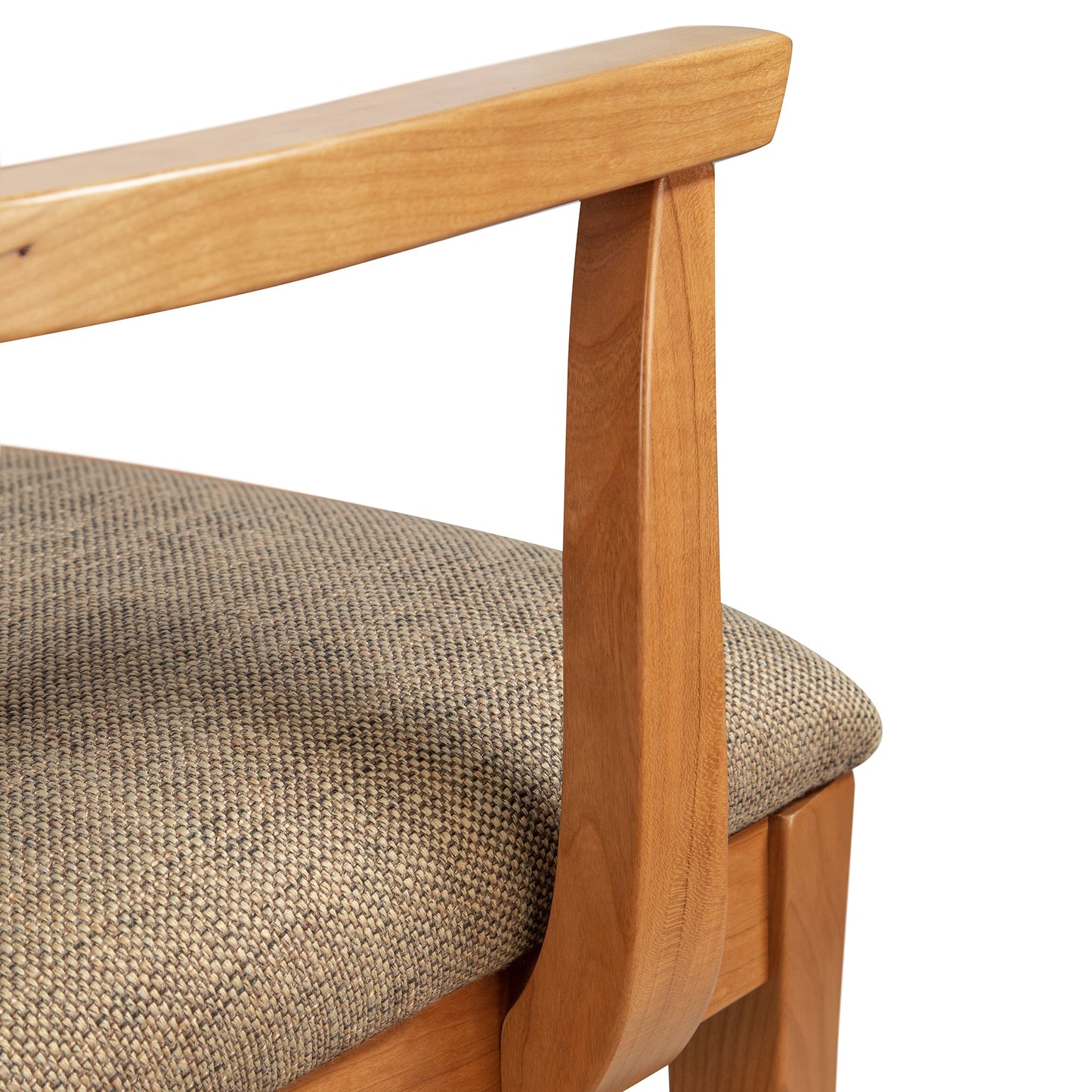 A close up of a Vermont Woods Studios Contemporary Shaker Arm Chair with Barley Upholstery - Ready to Ship wooden chair with a fabric upholstered seat and contemporary design.