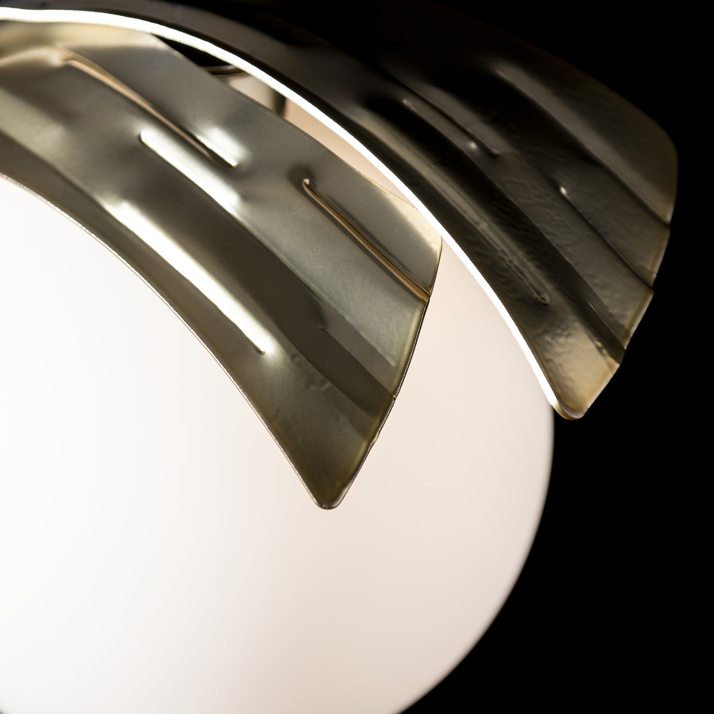 Hubbardton Forge Crest Table Lamp with hand-forged steel and curved panels in modern brass finish.
