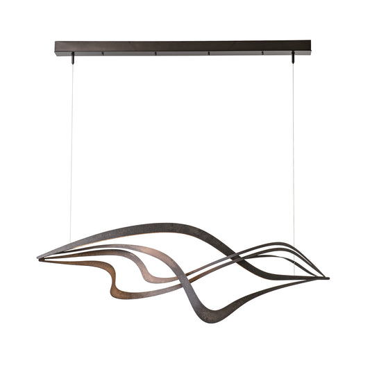Hubbardton Forge Crossing Waves Pendant showcases elegant curved metal strips in a wave pattern, hanging from a sleek rectangular ceiling mount.