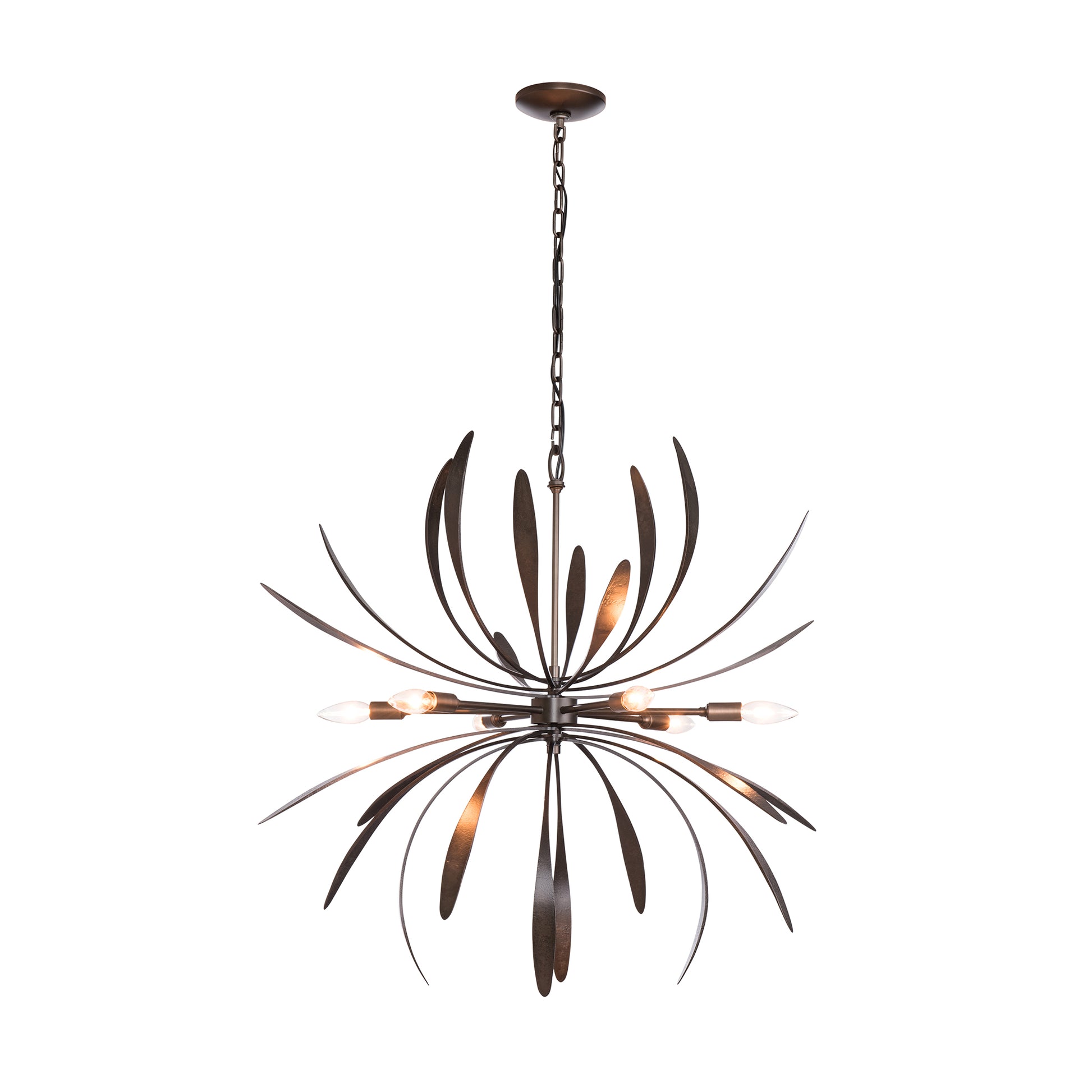 The Hubbardton Forge Dahlia Chandelier is a masterpiece of handcrafted lighting, featuring a large metal leaf gracefully hanging from it.