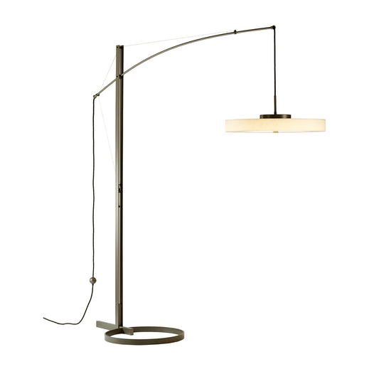A Hubbardton Forge Disq Arc Floor Lamp with a white shade.