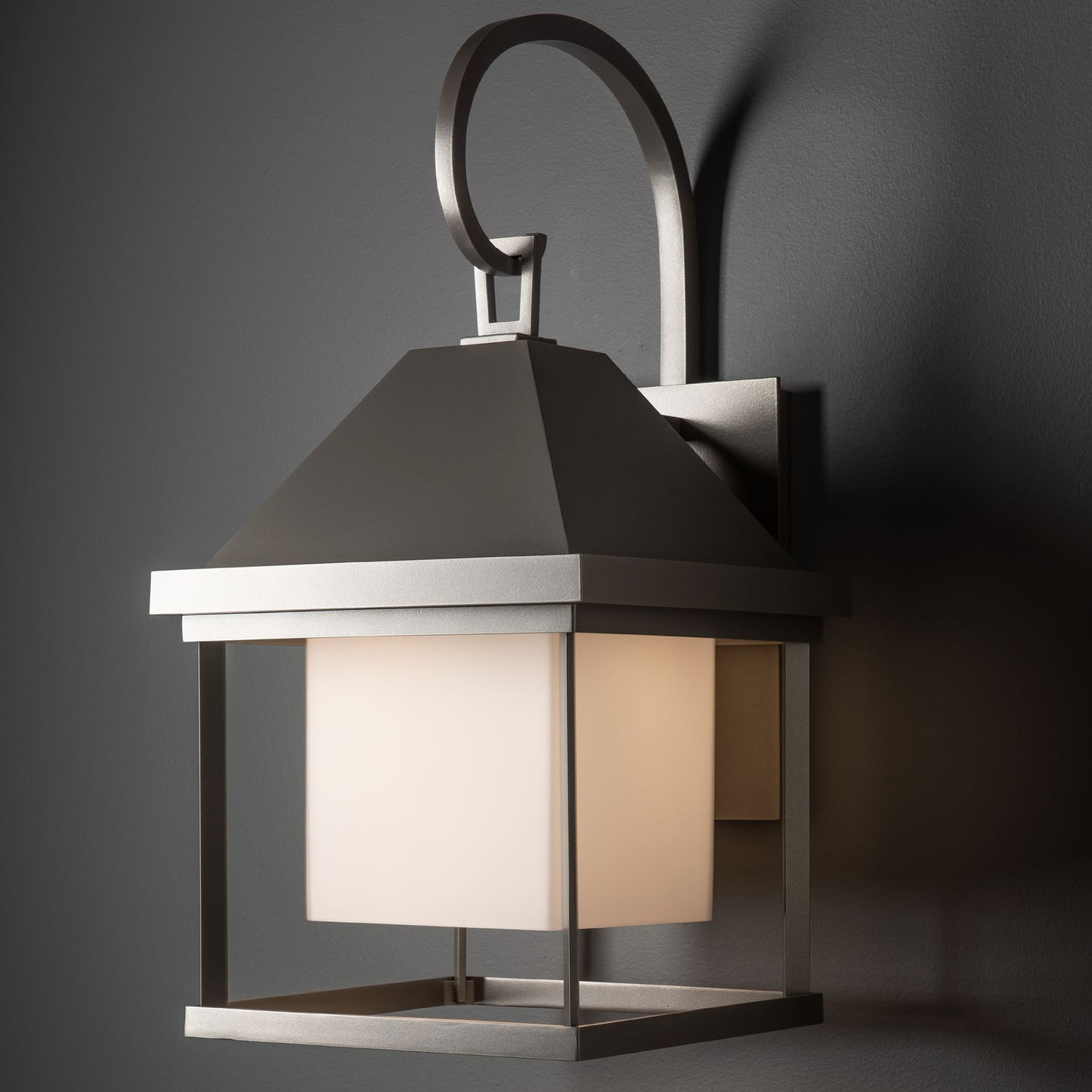 Hubbardton Forge Dorset Medium Dark Sky Friendly Outdoor Sconce with square frosted glass shade and hand-forged steel construction.