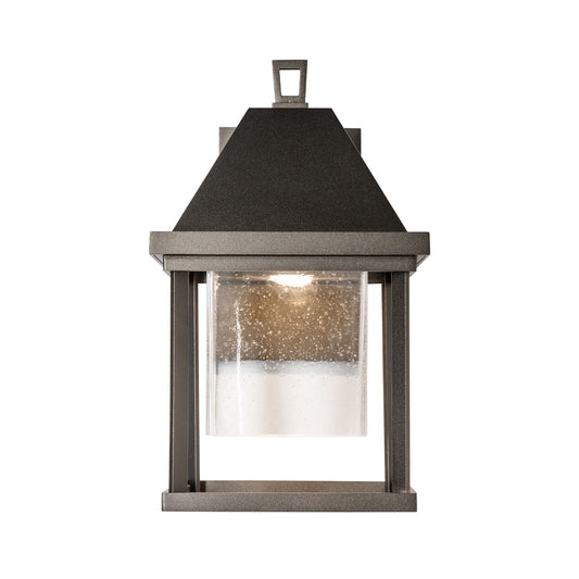 Dorset Small Outdoor Sconce by Hubbardton Forge with clear seeded glass and dark metal frame, showcasing elegant, high-end craftsmanship.