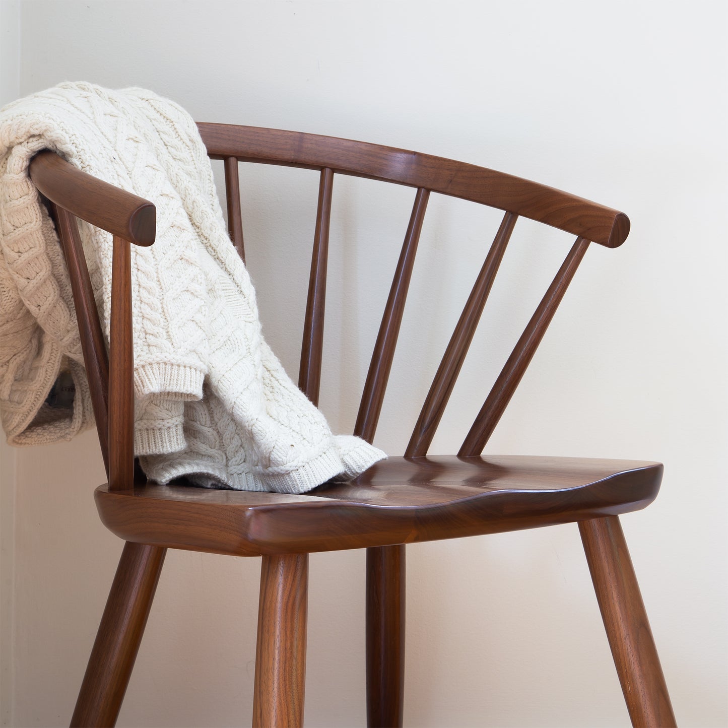 Dover Curveback Windsor Chair by Vermont Woods Studios, American made with expert craftsmanship, shown partially covered by a cream cable knit sweater.