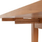 A close up of a Lyndon Furniture drop leaf table with a shelf in a kitchen or dining room.
