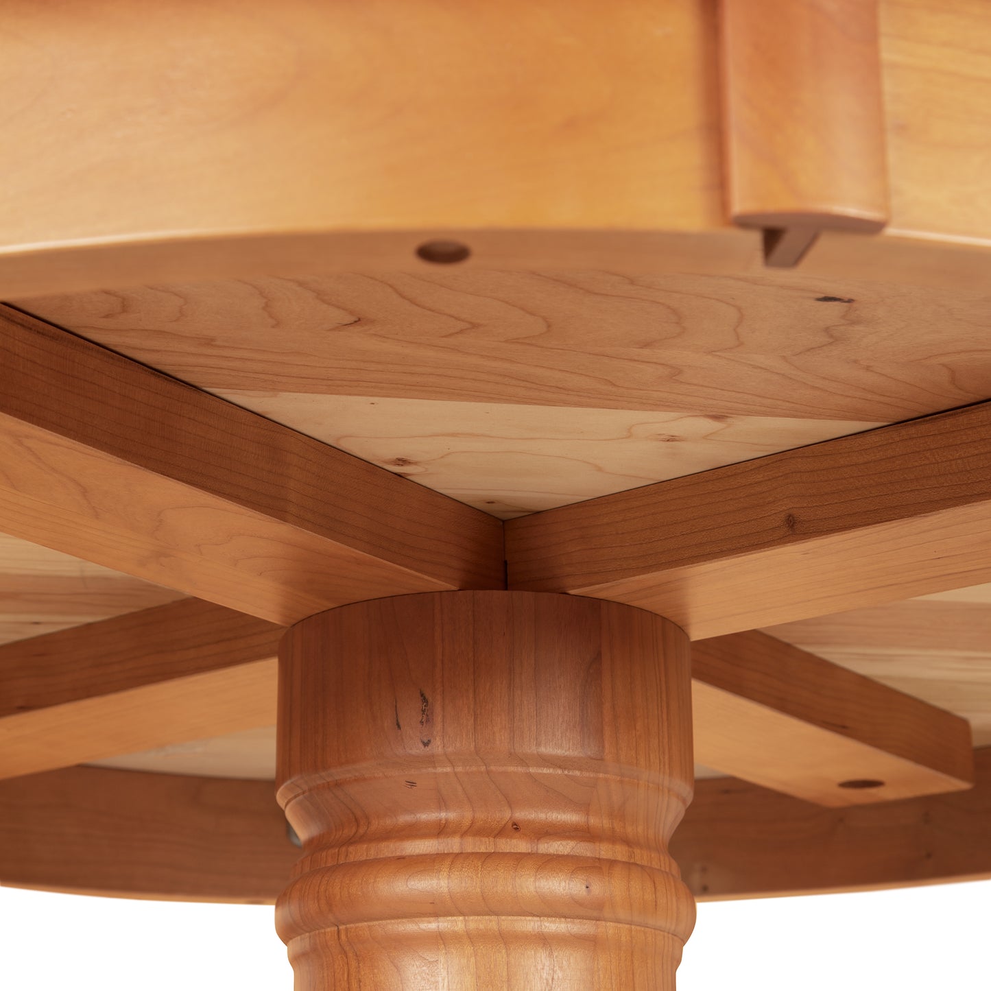 Detailed view of the Duncan-Phyfe Round Pedestal Dining Table by Lyndon Furniture, highlighting the pedestal base, support beams, and craftsmanship of the feet.