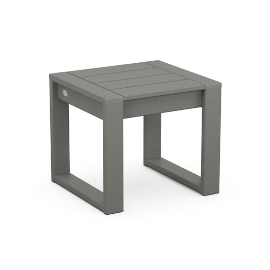 3D rendering of a simple, modern outdoor side table named POLYWOOD EDGE End Table, made of planks, featuring a square top and a sturdy, open-frame base. One visible screw is on the side.